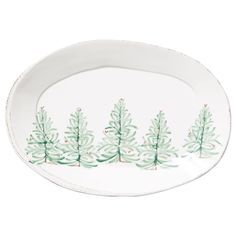 a white plate with green trees painted on it