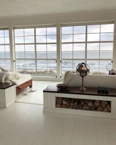 a living room filled with furniture and large windows