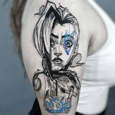 a woman's shoulder with a drawing on it and blue ink in the middle