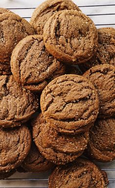 a pile of cookies sitting on top of a cooling rack