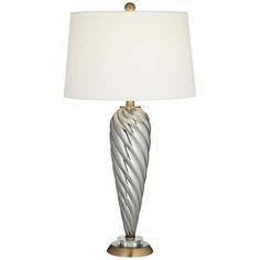 a silver lamp with a white shade on it