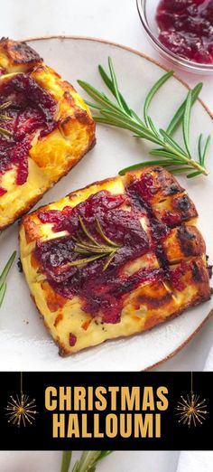 two pieces of bread on a plate with cranberry sauce and rosemary sprigs