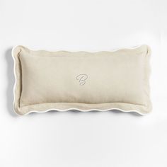 an embroidered pillow with the letter f on it's side and a white background