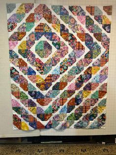 a large quilt hanging on the wall