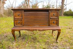 an old wooden desk sitting in the grass