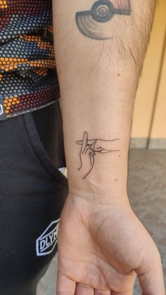 a person with a small tattoo on their wrist