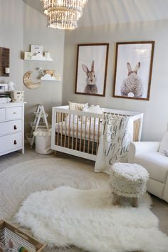 a baby's room with white furniture and pictures on the wall