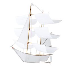 a model sailboat with white sails is shown on a white background, it appears to be floating in the air