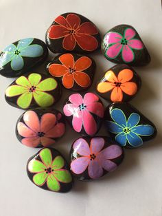 a group of painted rocks sitting on top of a table