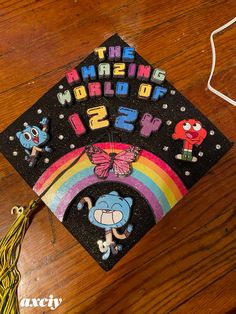 a graduation cap that has the words amazing world on it and an image of a cartoon character