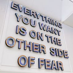 a sign that says everything you want is on the other side of fear with an interesting message