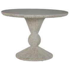 a white table with an oval top and fringed edges on the base, against a white background