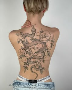 a woman with a tattoo on her back