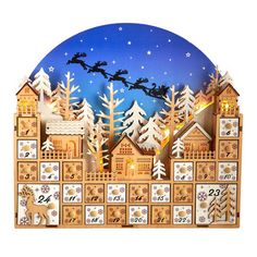 a wooden clock with santa's sleigh in the sky and snow covered trees