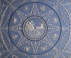 an intricately designed ceiling in the shape of a star with stars and flowers on it