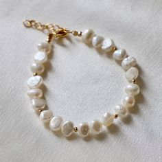 This beachy bracelet is an updated version of a classic. Freshwater nugget pearls Gold beaded accents Length: approx. 8" including extender Handmade in Utah by Katie Waltman Jewelry Adjustable Pearl White Beaded Bracelets With Pearl Drop, Adjustable Pearl Beaded Bracelets With Pearl Drop, Pearl White Adjustable Pearl Charm Bracelet, Adjustable Pearl Bracelet With Charm And Round Beads, Adjustable Baroque Pearl Drop Bracelets, Adjustable Pearl White Bracelet With Pearl Drop, Adjustable Beaded Pearl Bracelets With Pearl Charm, Adjustable Baroque Pearl Bracelet With Pearl Drop, Adjustable Beaded Pearl Bracelet With Pearl Charm