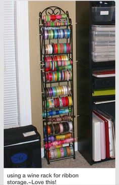 a book shelf filled with lots of different colored tapes