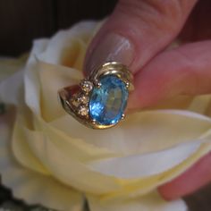 Vintage 14KT Yellow Gold Ring is gorgeous. Two Plus CT Large Oval Blue Topaz Ring with Three Nice Size Genuine Diamonds on One Side of Band. The Gold Band has a Double Swirl on One Side and this Ring is a Size 5. Ring is Hallmarked inside of Band 14K with Maker's Mark. Three Oval Diamonds and they are a nice size. In excellent vintage condition. FREE SHIPPING. Where can you find a Genuine Diamond 14KT Gold Ring with a Lovely large Blue Topaz - Perfect Holiday Gift SANTA CLAUS IS COMING TO TOWN - Fine Jewelry Topaz Ring With Gemstone Accents For Anniversary, Unique Formal Topaz Ring, Heirloom Blue Topaz Ring, Turquoise Topaz Ring For Anniversary In Fine Jewelry Style, Fine Jewelry Turquoise Topaz Ring For Anniversary, Topaz Ring With Gemstone Accents For Anniversary, Oval Blue Topaz Gemstone For Anniversaries, Oval Blue Topaz Gemstone For Anniversary, Heirloom Topaz Ring With Gemstone Accents As Gift