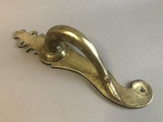 an antique brass door handle on a white background