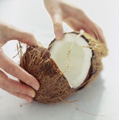 someone is peeling the inside of a coconut