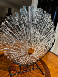 a glass sculpture sitting on top of a wooden table