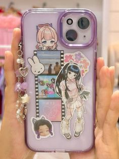 a person holding up a phone case with stickers on it