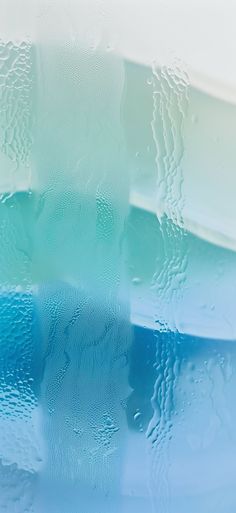 some blue and green water with drops of water on the bottom, as well as an abstract background