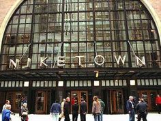 people are standing in front of a building with the name miketown written on it