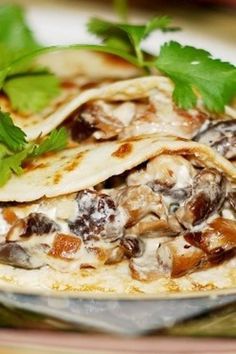 three tortillas with mushrooms and parsley on a plate