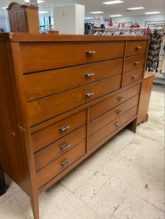 a large wooden dresser sitting inside of a store