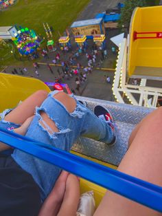 two people are sitting on a carnival ride