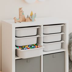 a toy storage unit with bins and toys on it in a child's room