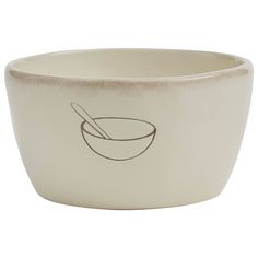 a white bowl with a spoon in it