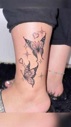 a woman's foot with butterfly tattoos on it