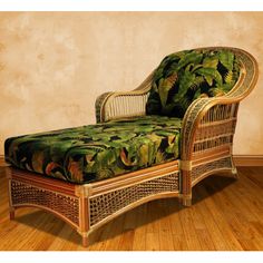 a wicker chaise lounge chair with tropical print upholster