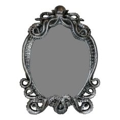 an ornate silver mirror on a white background