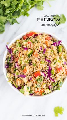 rainbow quinoa salad in a white bowl with lettuce and carrots