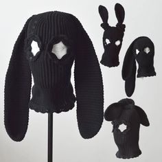 a knitted hat, sweater and bunny ears are on display