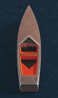 an overhead view of a boat in the water with orange and black seats on it