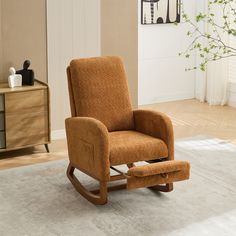 a brown rocking chair sitting on top of a white rug