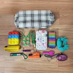 the contents of a purse are laid out on the floor