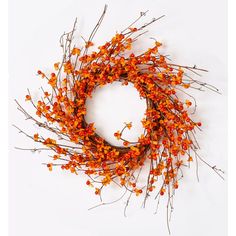 an orange twig wreath with red berries on white background for halloween decoration or home decor