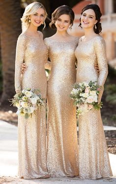 three bridesmaids in gold sequin gowns and bouquets smiling at the camera