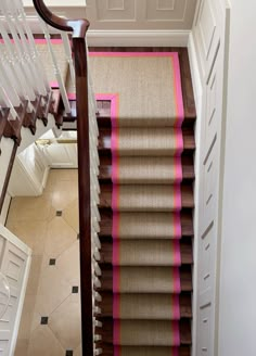 the stairs are lined with pink and brown carpet