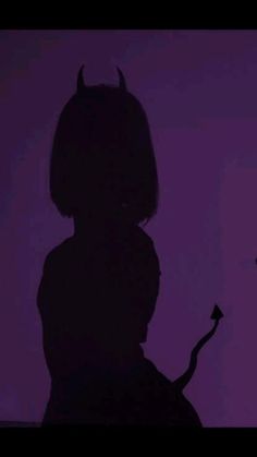 the silhouette of a person with horns on their head is shown in front of a purple background