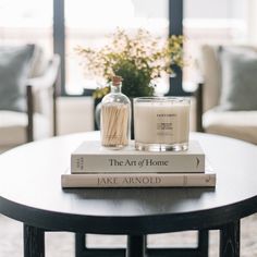 two books are stacked on top of each other in front of a vase with flowers