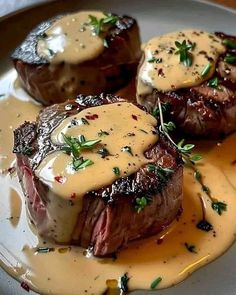 the steaks are covered in sauce and garnished with parsley