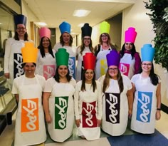 a group of women in colorful hats and aprons