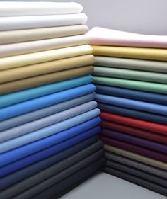 a stack of different colored sheets sitting next to each other