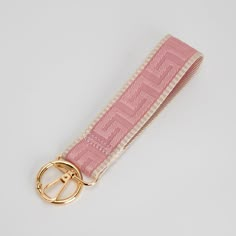 a pink key chain with a gold ring